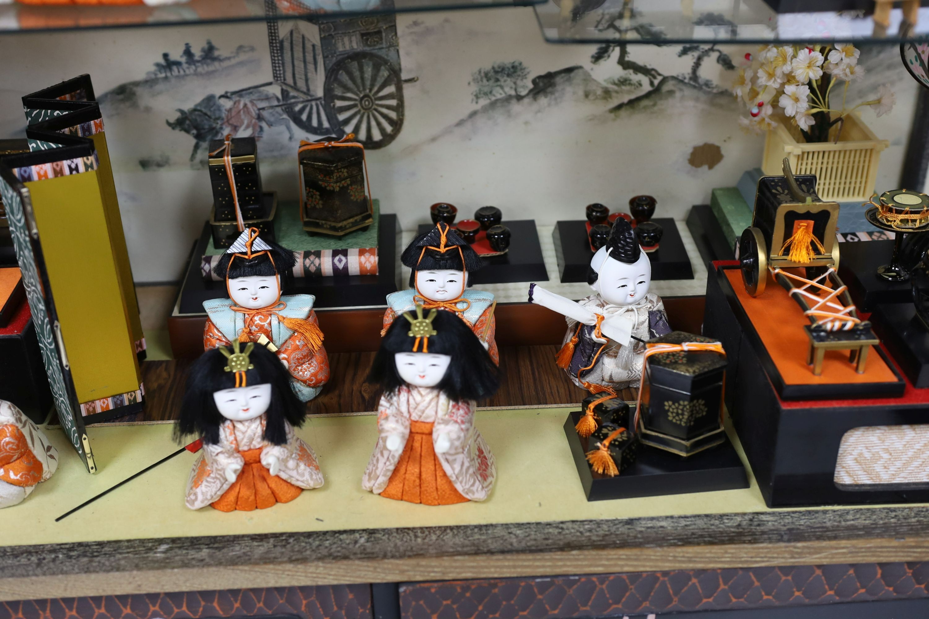 A 20th century Japanese diorama, (Hinamatsuri), depicting the Emperor's Court in an open cabinet, cabinet 84 cms wide x 69 cms high.